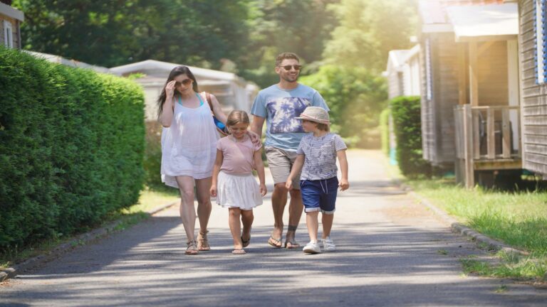 Family walking through holiday park